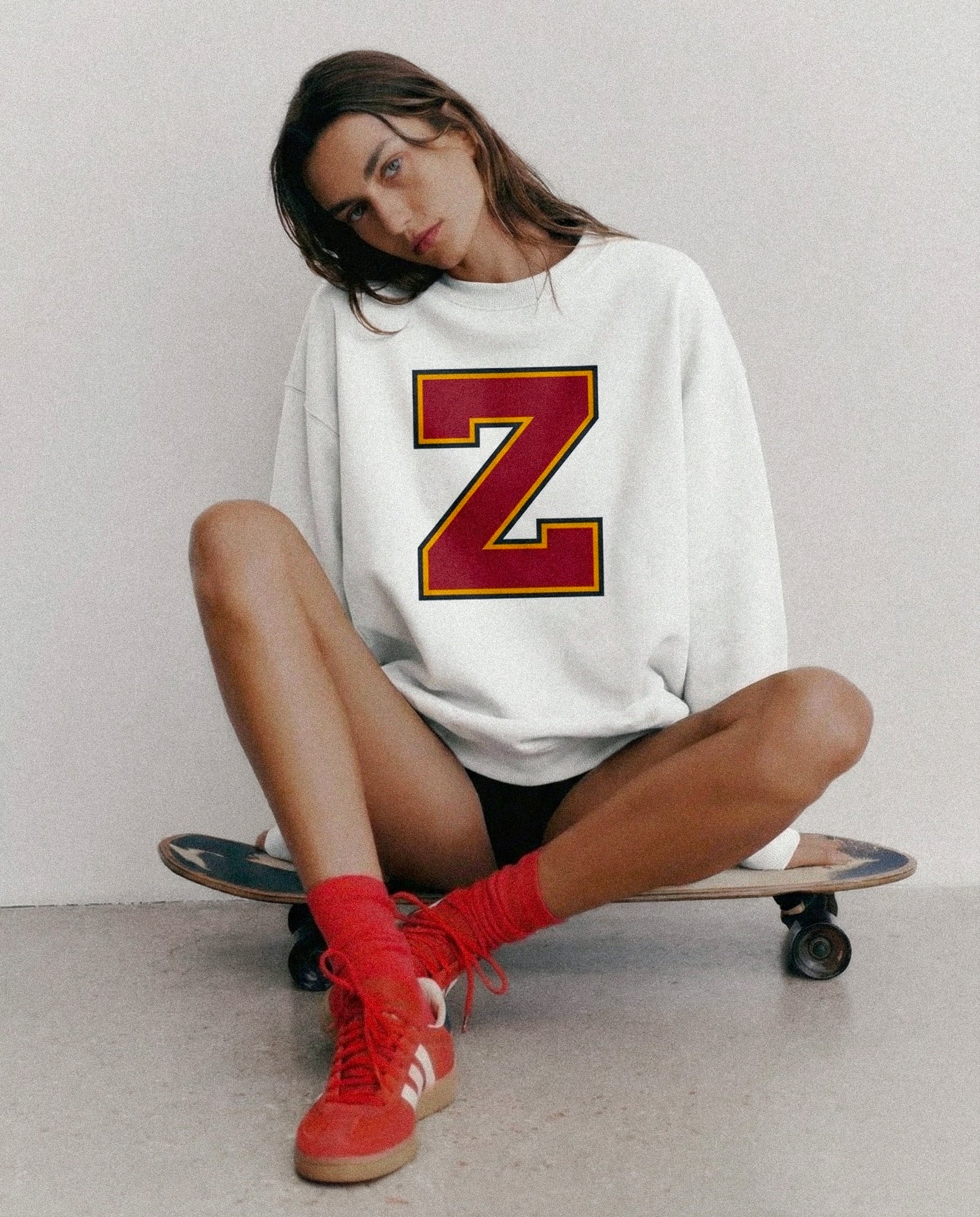 Woman wearing Baron & Buck varsity monogram Z sweatshirt, relaxed fit premium cotton streetwear
