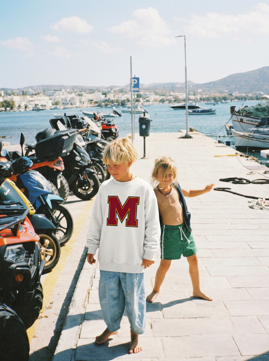 Child wearing a Baron & Buck kids varsity monogram sweatshirt in white, reflecting classic collegiate style made to match across generations.