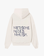 Back view of Baron & Buck marshmallow hoodie featuring black text that reads, “Nietzsche. Nudes. Nihilism.” — a soft, poetic streetwear statement.