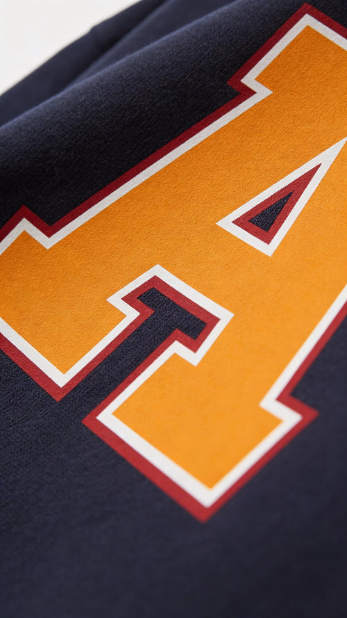 Close-up of varsity monogram letter A print on French Navy cotton sweatshirt