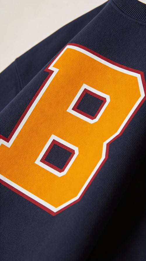 Close-up of varsity monogram letter B print on French Navy cotton sweatshirt