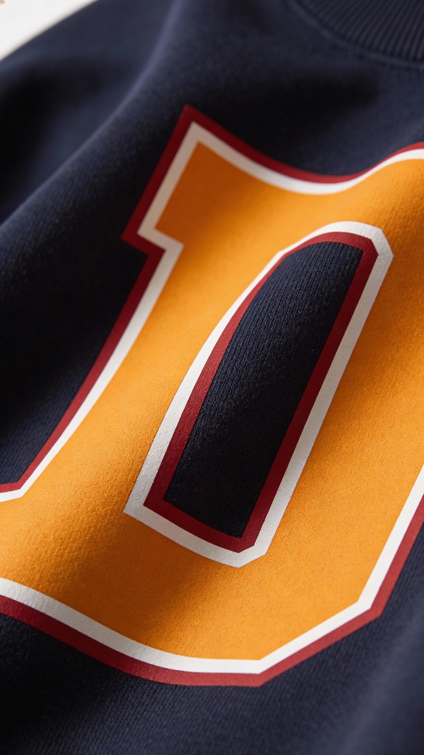 Close-up of varsity monogram letter D print on French Navy cotton sweatshirt