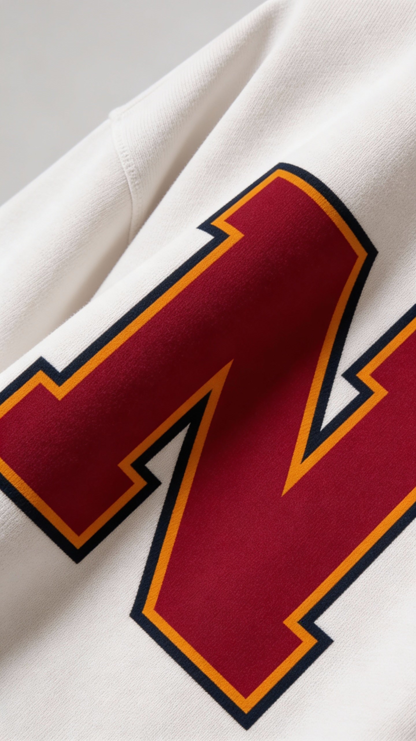 Close-up of varsity monogram letter N print on White cotton sweatshirt