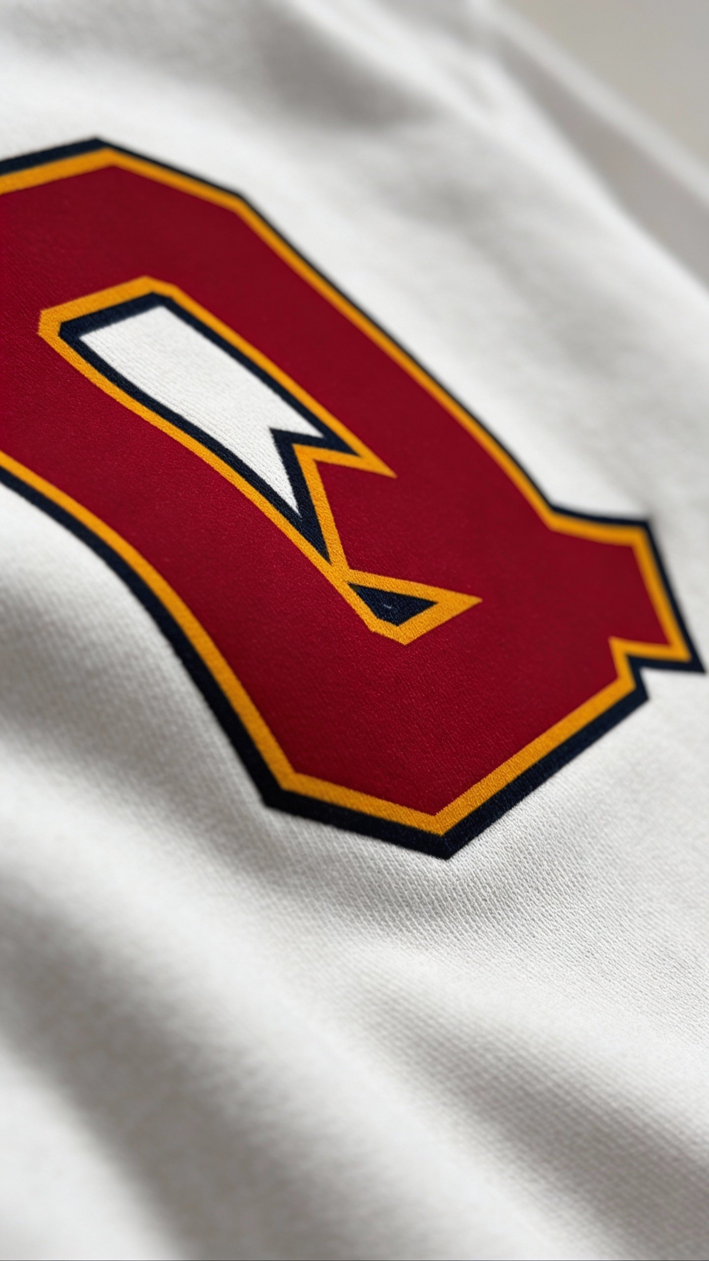 Close-up of varsity monogram letter Q print on White cotton sweatshirt