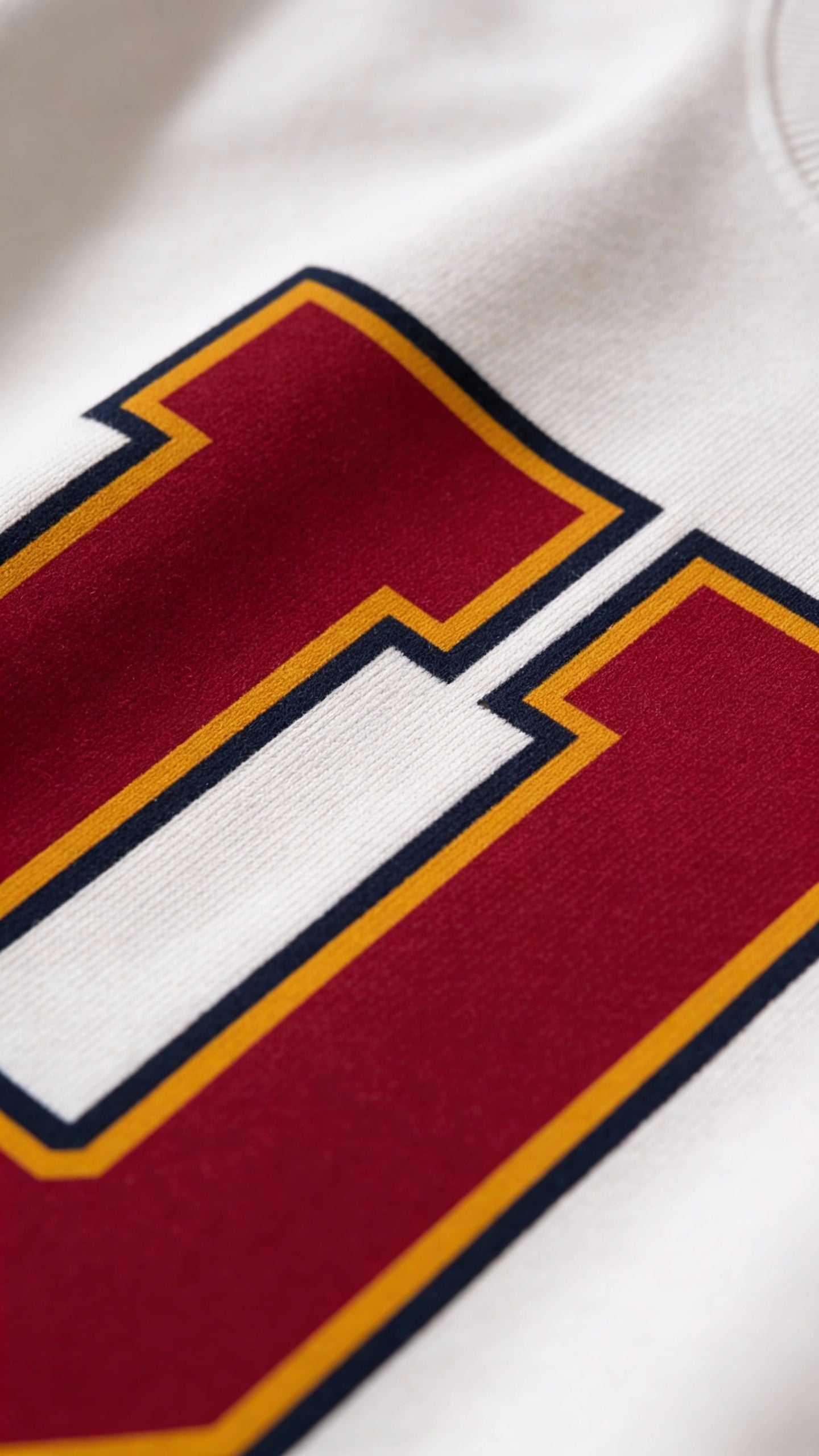 Close-up of varsity monogram letter U print on White cotton sweatshirt