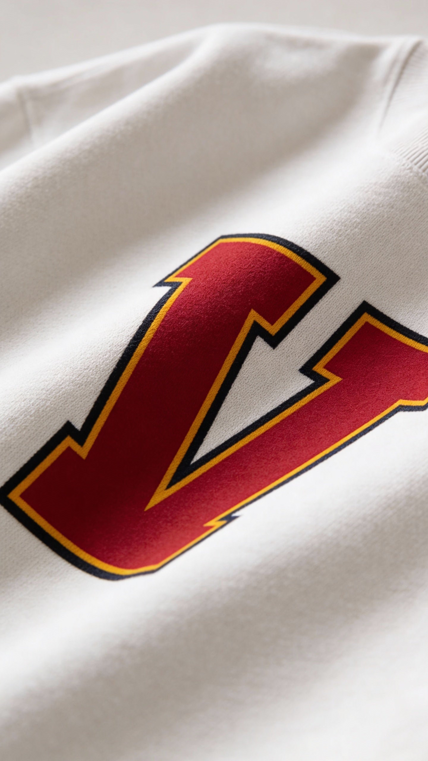 Close-up of varsity monogram letter V print on White cotton sweatshirt