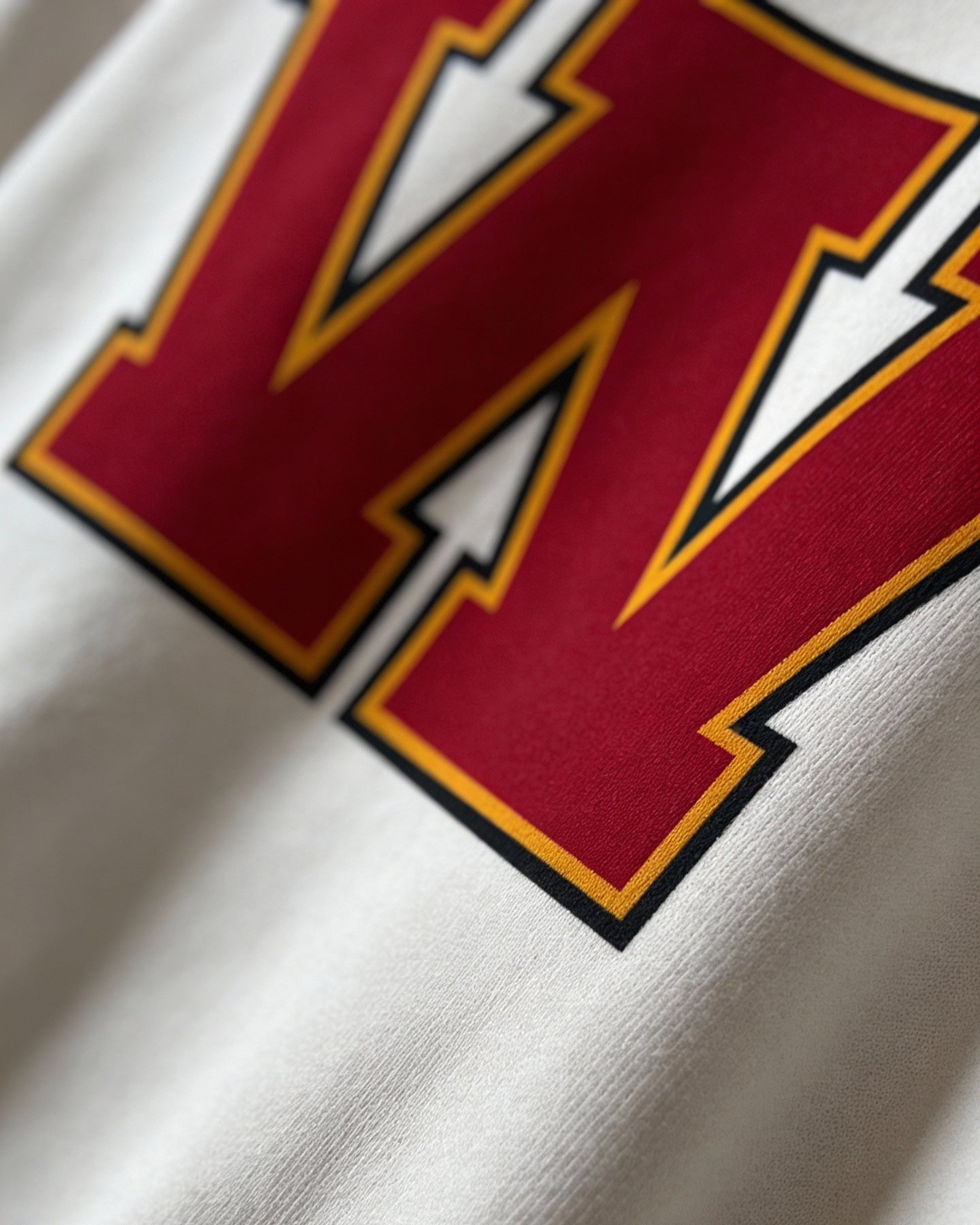 Close-up of varsity monogram letter W print on White cotton sweatshirt