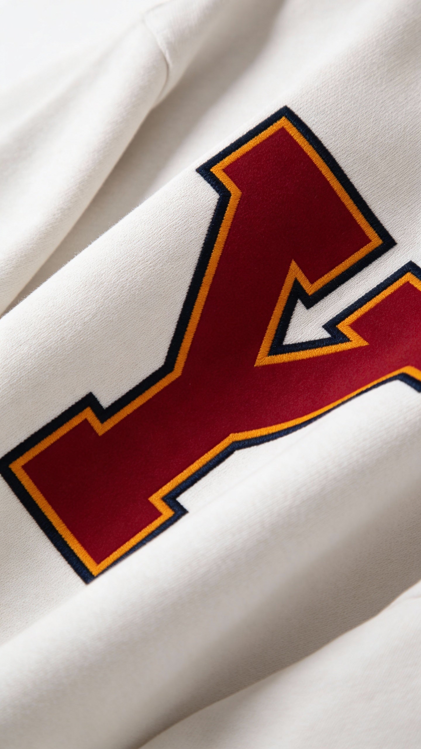 Close-up of varsity monogram letter Y print on White cotton sweatshirt