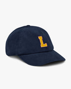 Side angle of Baron and Buck varsity monogram corduroy hat in Oxford Navy, showing embroidered monogram and structured crown